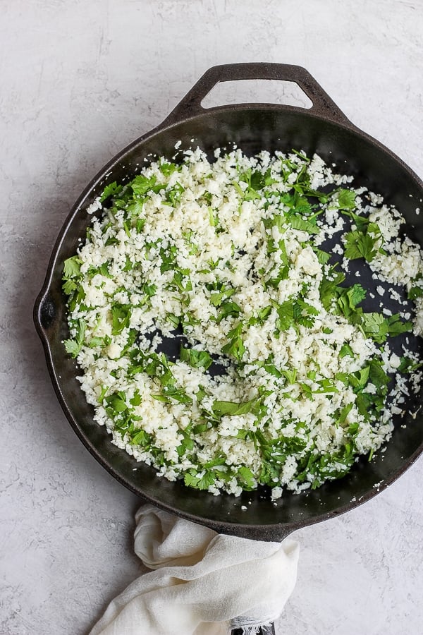 Cilantro Lime Cauliflower Rice in a cast iron skillet. 