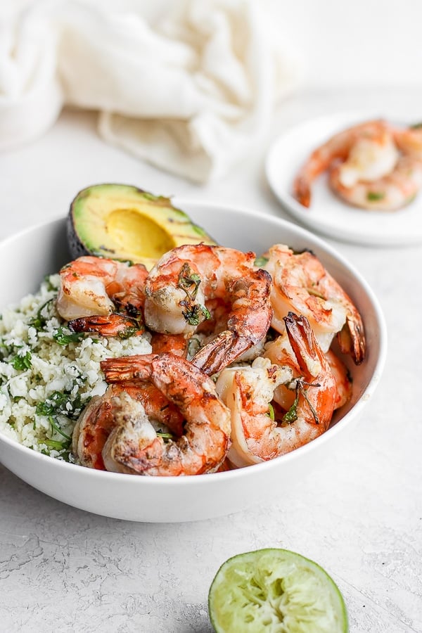 Bowl of cilantro lime cauliflower rice, grilled avocado and cilantro lime shrimp. 