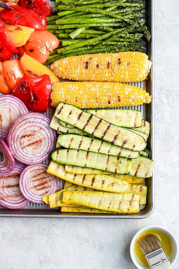 All the grilled vegetables on a baking sheet after being grilled.