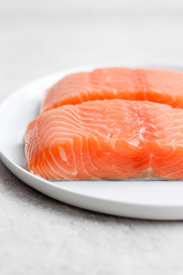 Salmon fillets on a white plate.