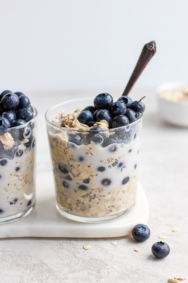 Glass filled with blueberry overnight oats. 
