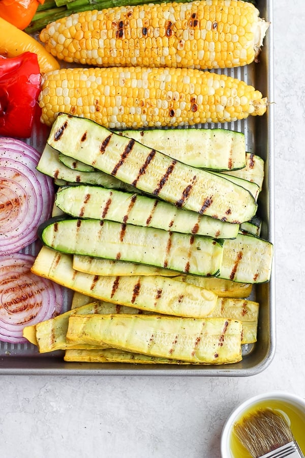 A variety of grilled vegetables on a baking sheet.