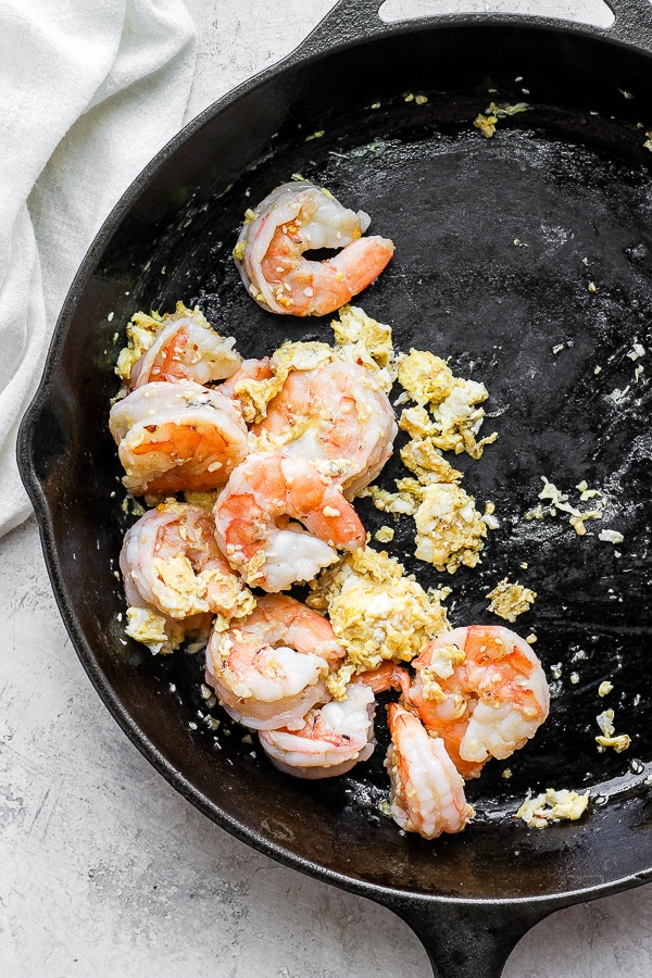 Pan fried shrimp and egg in a cast iron skillet. 
