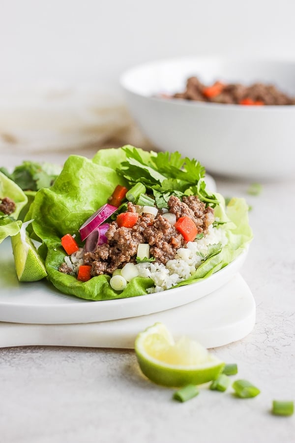 A ground beef lettuce wrap on a white plate.