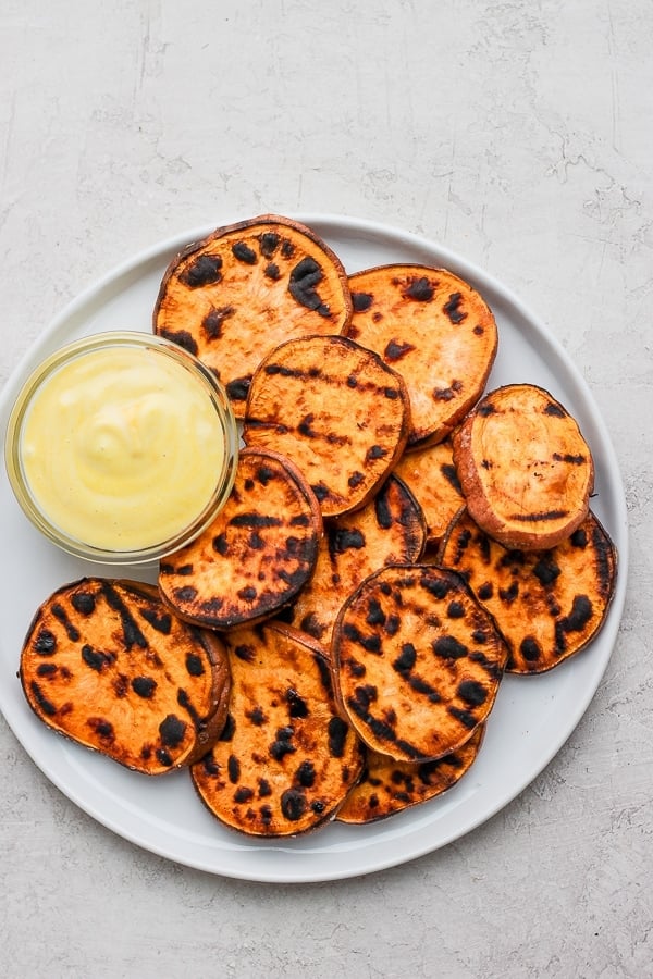 Plate of grilled sweet potatoes with mustard mayo sauce. 