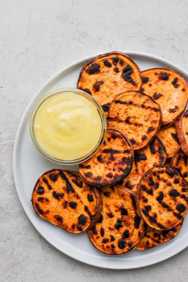 Plate of grilled sweet potatoes with mustard mayo sauce. 