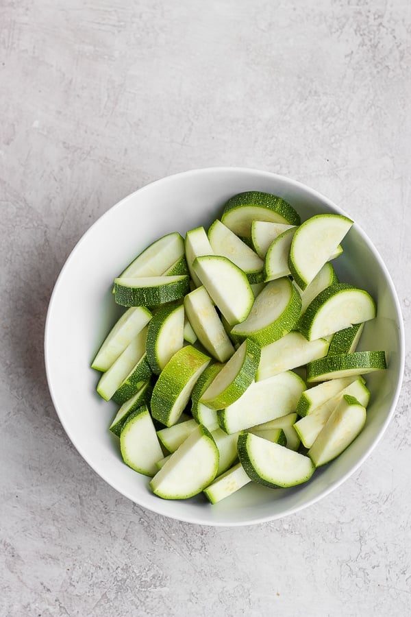 Zucchini slices in a white bowl.