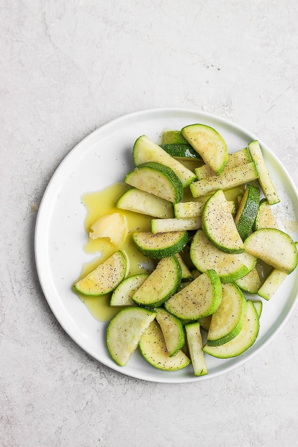 Sautéed zucchini on a white plate.