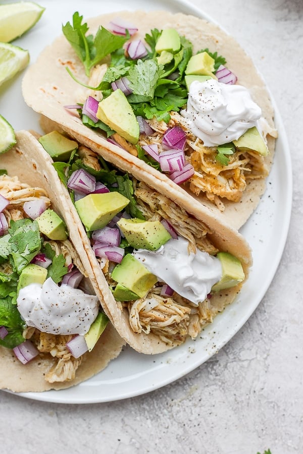 Salsa verde chicken tacos on a plate. 