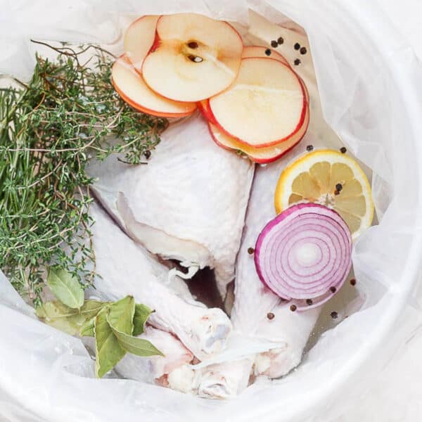 A whole turkey sitting in a smoked turkey brine.