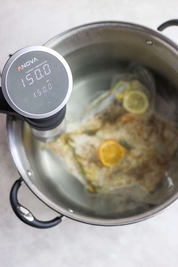 A bag of chicken breasts in water with a sous vide at 150 degrees F.