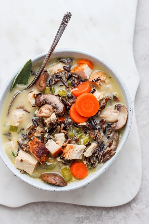 A bowl of turkey wild rice soup with a spoon.