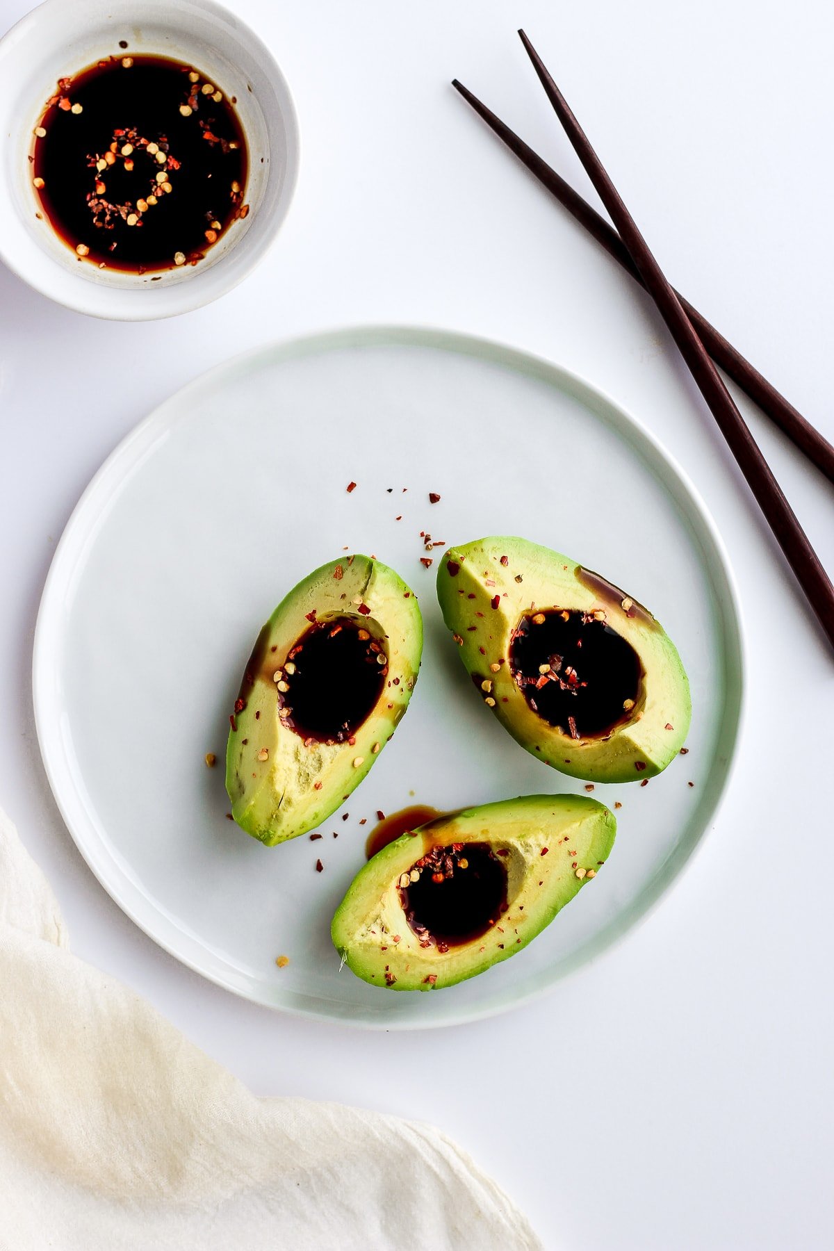 Plate with avocado and coconut aminos. 