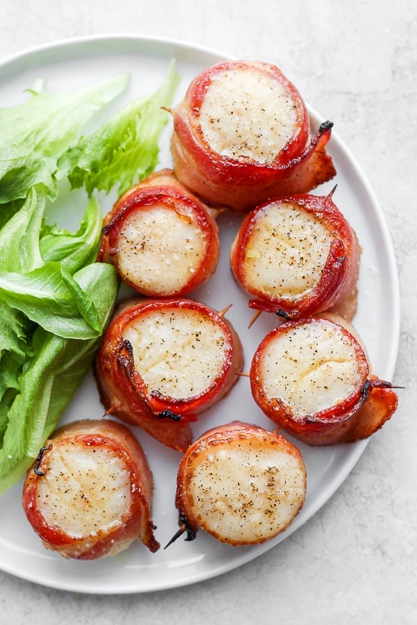 Bacon wrapped scallops on a plate.