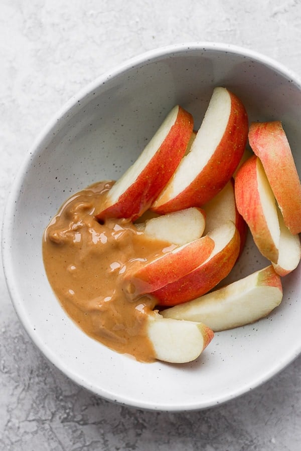 Bowl of apples with almond butter.