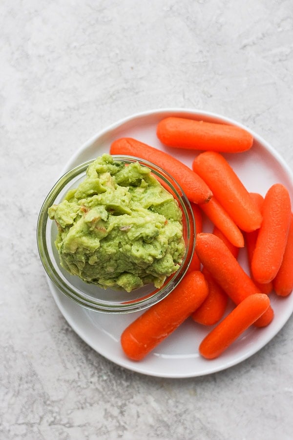Plate of carrots with guacamole. 