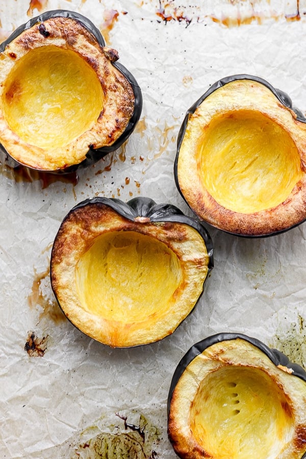 Close-up view of fully roasted acorn squash halves.