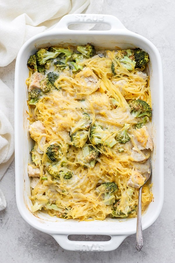 Baking dish with all the chicken, Alfredo sauce, broccoli, and spaghetti squash all mixed together.