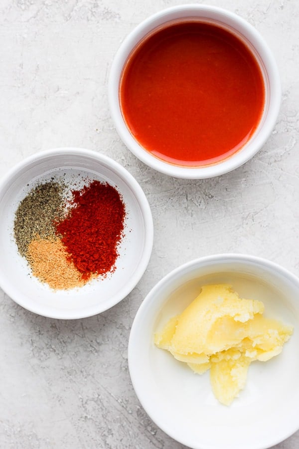 Ingredients for buffalo sauce in separate bowls.