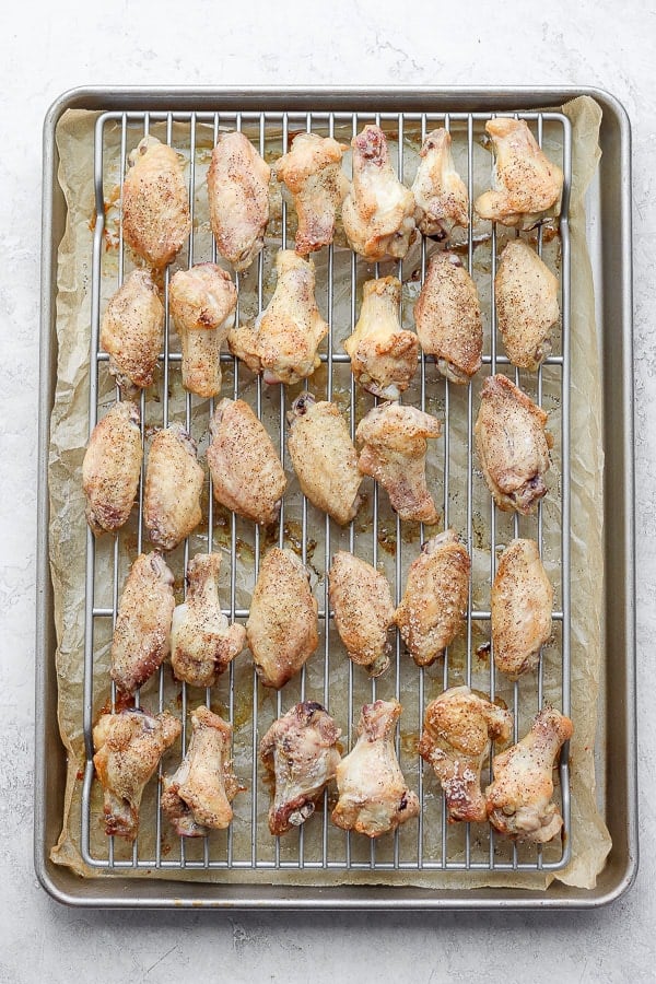 Fully cooked chicken wings on the wire rack.