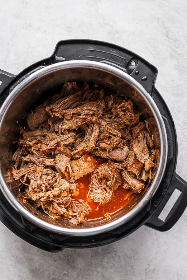 Instant Pot with pulled pork inside. 