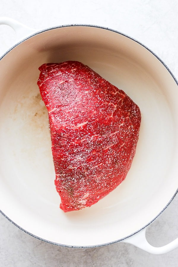 A seasoned chuck roast searing in a dutch oven.