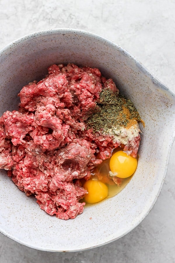 All of the meatball ingredients in a mixing bowl.