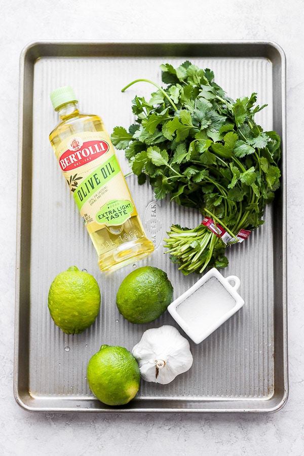 Ingredients for a cilantro lime marinade sitting on a baking sheet. 