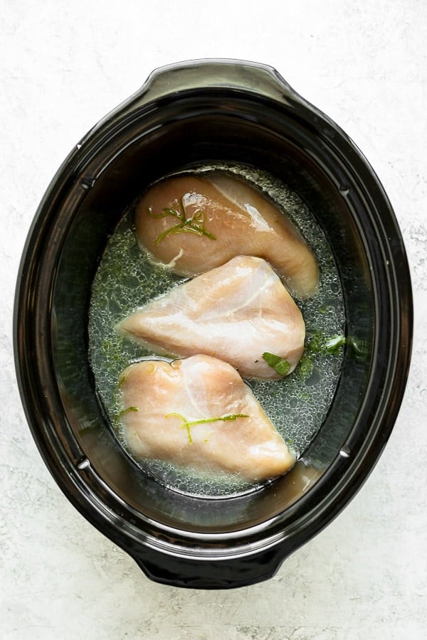The chicken breasts and marinade in the slow cooker.