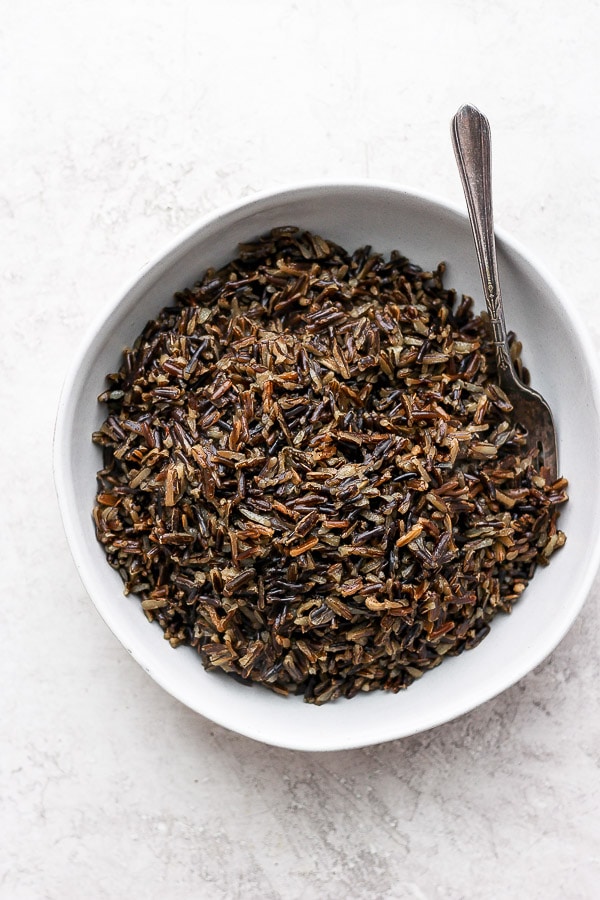 Instant Pot Wild Rice in a white bowl with a fork.