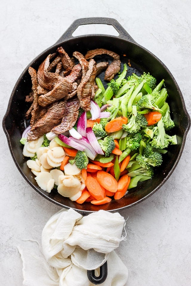 The steak added back to the skillet with the stir fried veggies.