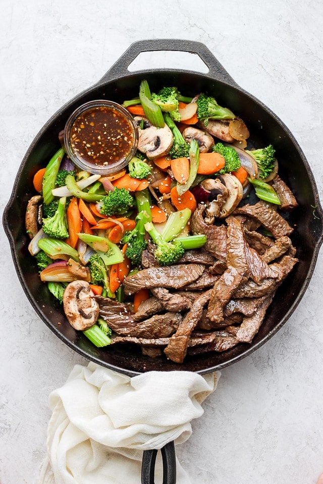 Homemade stir fry sauce added to the pan and tossed with all the steaks and veggies.