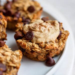 A baked oatmeal cup with almond butter and cinnamon on top.