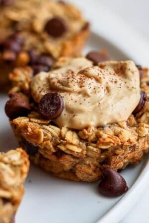 A baked oatmeal cup with almond butter and cinnamon on top.