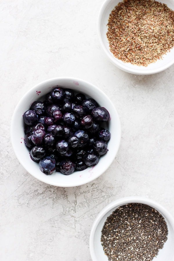 Ingredients for blueberry banana smoothie in bowls. 