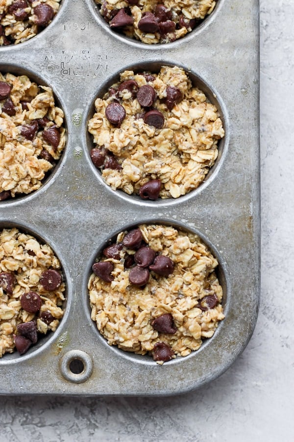 The baked oatmeal mixture in muffin tins before cooking. 