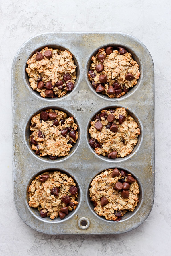The baked oatmeal cups in muffin tins after cooking. 