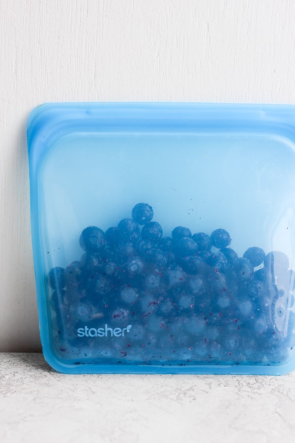 Frozen blueberries in a silicone storage bag.