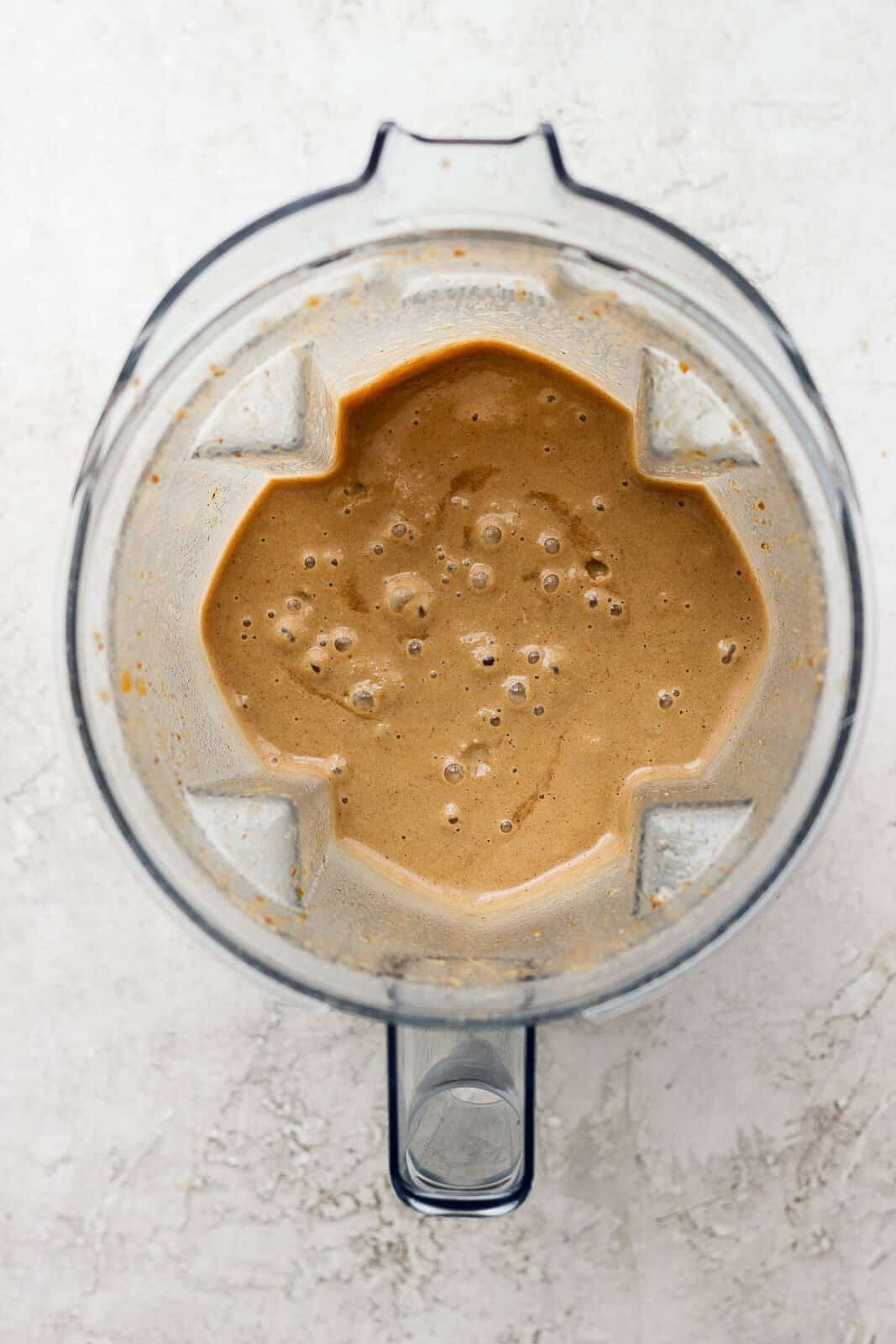 A coffee smoothie all blended up in a blender.