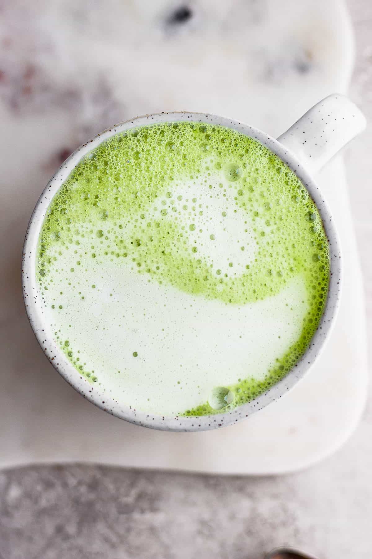 Top shot of a mug of a matcha latte.