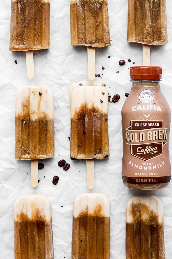 Eight coffee popsicles on a piece of parchment paper. 