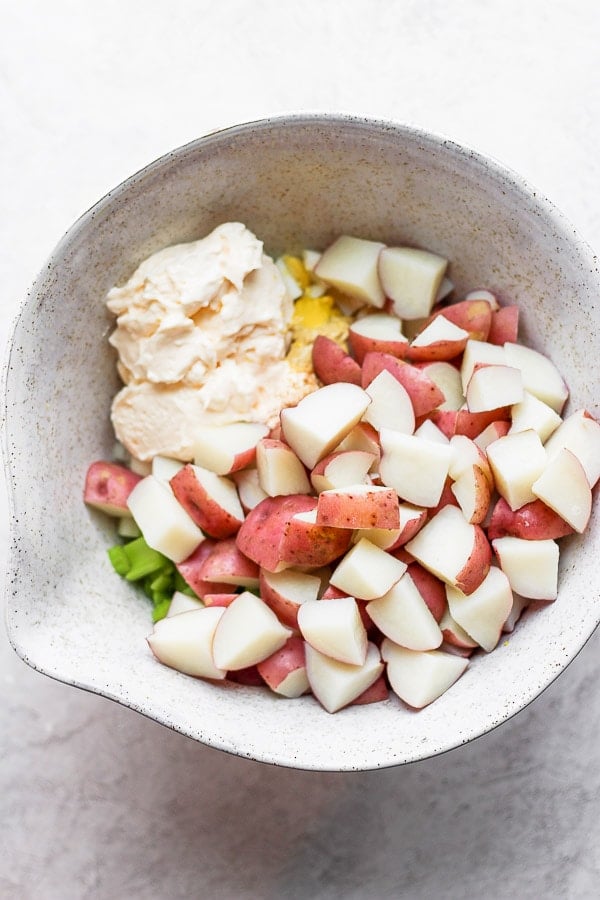 Cooked potatoes added to the mixing bowl.