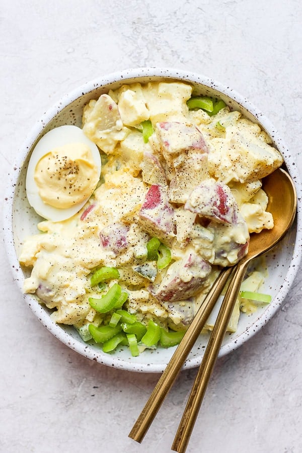 Deviled Egg Potato Salad on a plate with two spoons.
