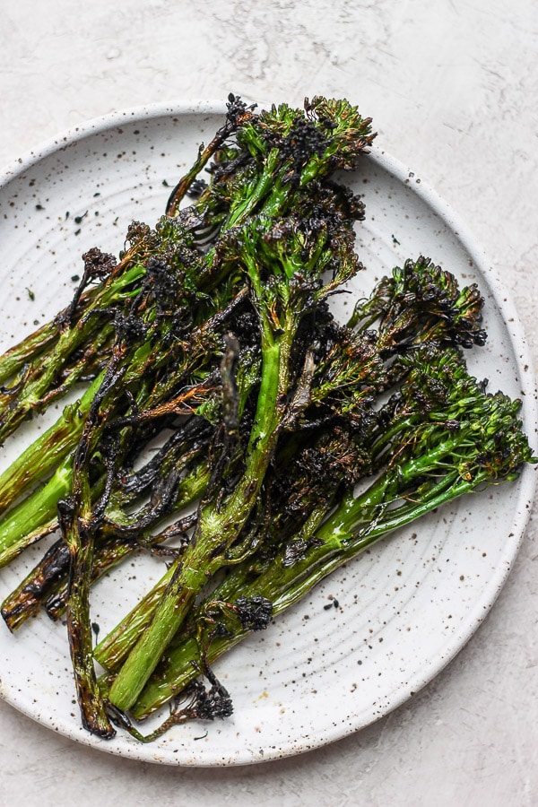 Grilled broccolini on a plate.