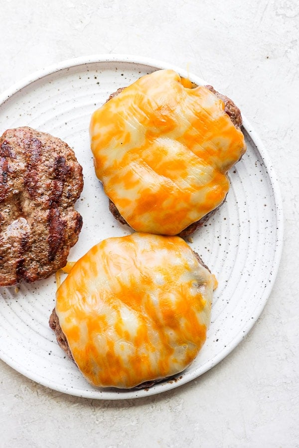 A plate of cheeseburgers. 