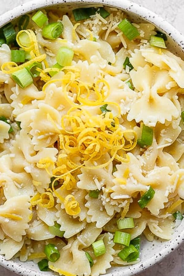Bowl of lemon pasta with lemon zest on top.