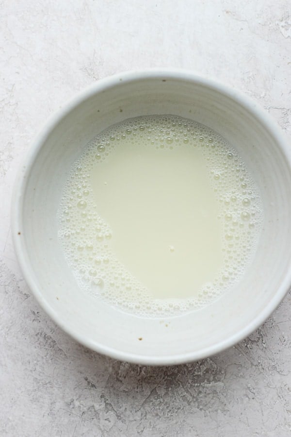 Egg whites and almond milk whisked together in a small bowl.
