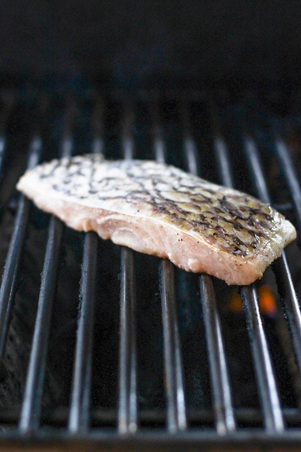 A piece of red snapper on the grill. 
