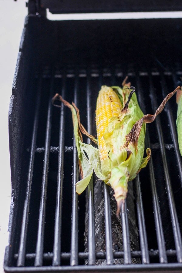 A piece of corn on the cob on the grill. 