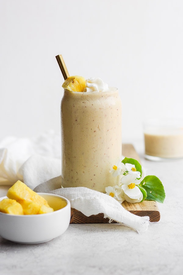 A creamy pineapple smoothie in a glass.